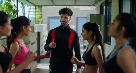 Indian young adult gen z sports woman lady group team fit coach man talk speak share plan ideas day...