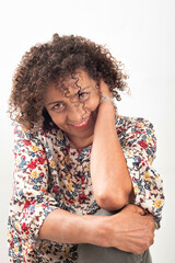 Smiling  latin woman with curly hair in floral blouse