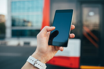Person is holding a cell phone in their hand