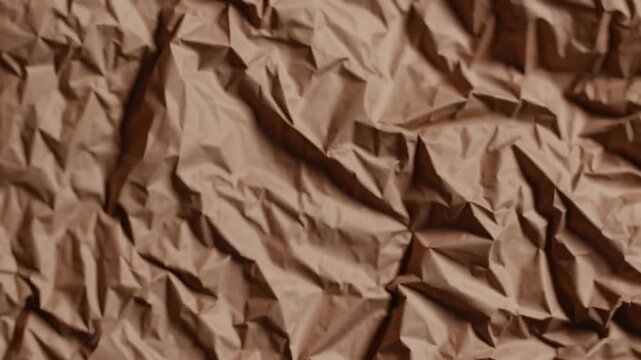 sheet of paper material in brown hue that has been compressed to create textured surface