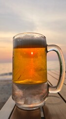 Beer glasses on a beach table in the evening