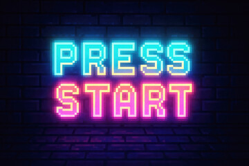 Neon Pixelated Press Start Sign Glowing Blue and Pink on Brick Wall with Floor image photo