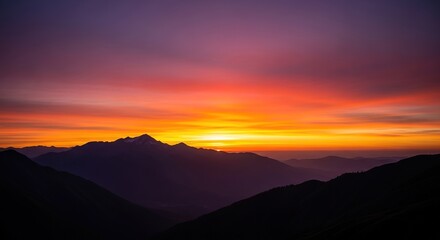 Fiery Sunset Over Mountain Ridges: A Silhouette of Peaks Against