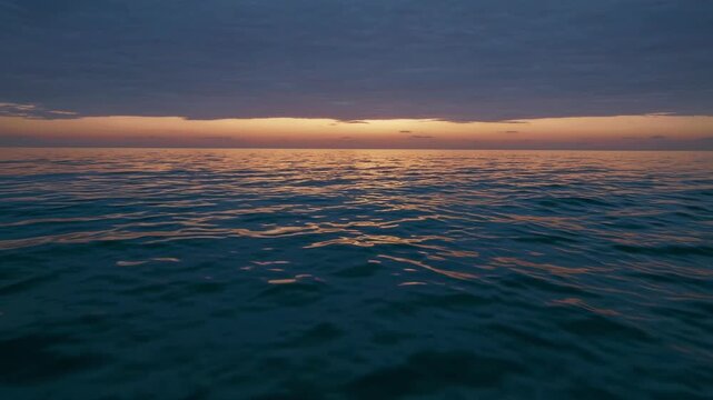 Serene Ocean Sunset With Calm Waves and a Vibrant Horizon at Dusk, Capturing Tranquility and Natural Beauty in a Seascape