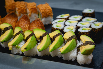 Fresh Avocado Sushi Rolls and Inari Tofu Pockets Selection