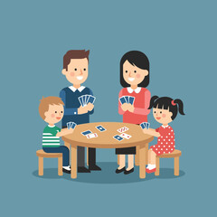 Family playing cards at a table indoors.