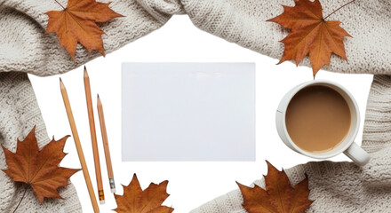 Autumn stationery scene with warm drink and leaves on cozy sweater