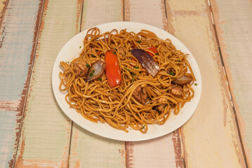 Traditional sautéed noodles with juicy strips of beef tenderloin, red onion, fresh tomato, and yellow chili, wok-sautéed with soy sauce and vinegar