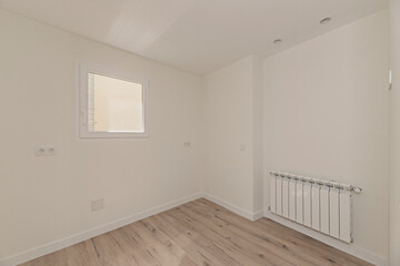 Walnut parquet flooring in an undecorated room, offering an elegant contrast with white walls