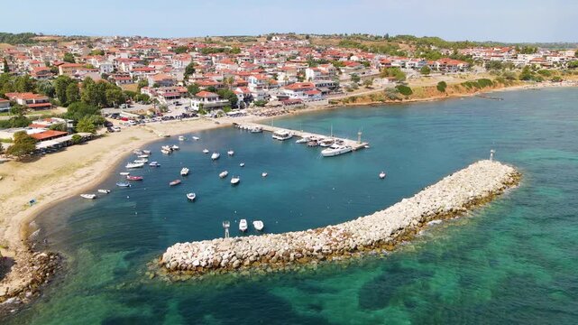 Nea Fokea beach, sea and hotels, Kassandra Halkidiki, Greece. Amazing sea with clear blue water. Aerial panoramic drone view from above, top view from drone. Summer holidays Europe
