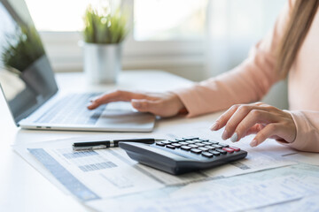 Deduction planning, debt asian young woman  hand using laptop computer, calculator calculating...