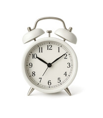 A white alarm clock shows the time on a black background