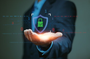 Cybersecurity concept with a digital padlock icon on shield in human hand, representing data protection, online security system, encryption technology and cyber defense.