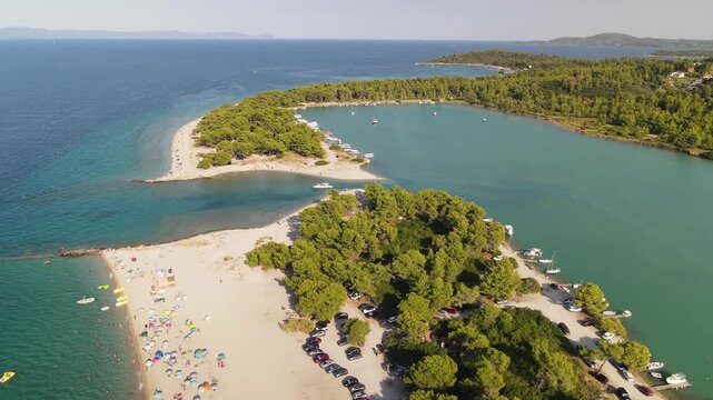 Port Glarokavos beach and sea, Kassandra Halkidiki, Greece. Amazing sea with clear blue water. Aerial panoramic drone view from above, top view from drone. Summer holidays Europe
