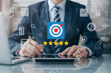 Businessman evaluating performance with target and star rating icons suit