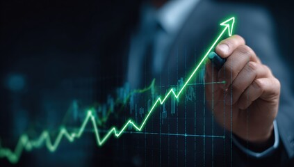 Businessperson drawing a rising stock market graph