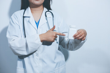 The pharmacist or doctor holding medication or medicine for treatment. Anti biotic pill in the vial.