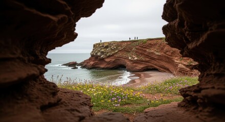 Majestic coastal red cliffs with wildflowers framing secluded beach scene