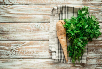 Fresh bunch of parsley leaves on a kitchen table. Window garden concept.