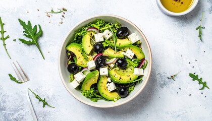 Fresh and Healthy Mediterranean-Inspired Salad with Creamy Avocado, Tangy Feta Cheese, and Briny Black Olives, Perfect for a Light Meal or Appetizer