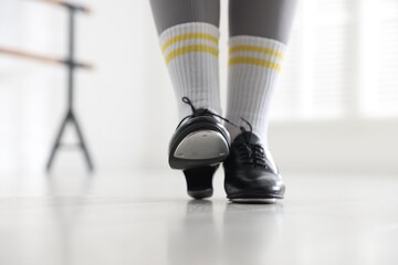 Teenage girl in tap shoes indoors, closeup