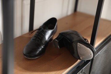 Pair of shoes for tap dance on cabinet indoors, closeup