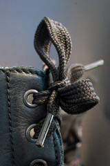 Macro photo of laces in a black boot type shoe.