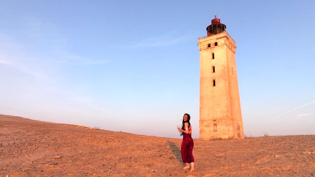Aerial view of the giant sand dunes with the famous lighthouse on the top of a hill. Rubjerg Knude Lighthouse, , North SeaRubjerg , Sunset at the lighthouse Rubjerg Knude Fyr near Lokken in Denmark. 