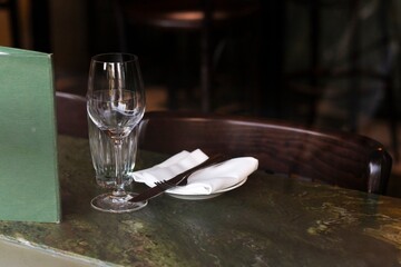Table setting with glassware and cutlery in a cozy restaurant during evening hours