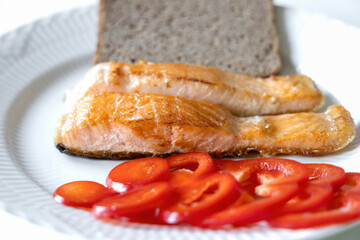 Fried fish served with bread and pepper