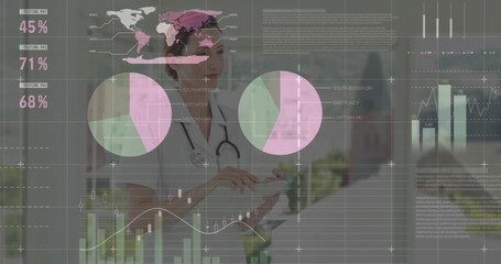 Standing female doctor holding tablet at hospital lobby, with stethoscope and data overlays