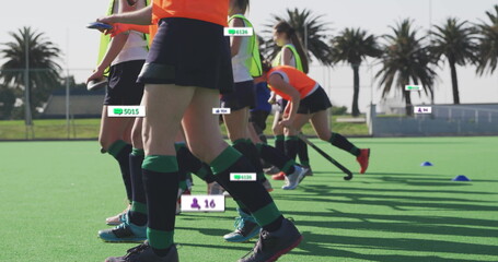 Sprinting teenage athletes practicing field hockey on coastal turf pitch, with floating data labels