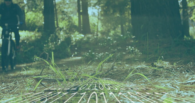 Riding cyclist wearing helmet, sunglasses, pedaling bike on pine trail with binary map, copy space