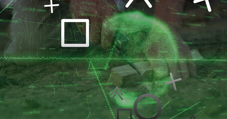 Interacting European man reaching toward green holographic overlay at desk with laptop and books