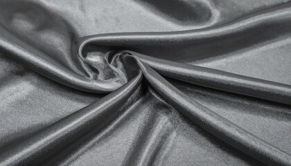 Luxurious silver satin cloth background with soft shadows and creases.