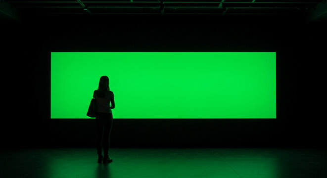 Woman gazes at vibrant green screen, perfect for creative projects and visual effects templates today - Powered by Adobe