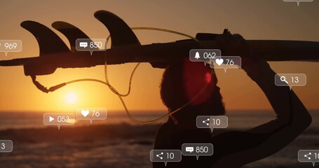 Walking surfer in wetsuit carrying surfboard on sunset beach, with leash, social icons, copy space