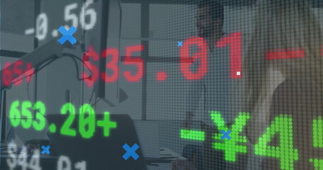Collaborating professionals in suits analyzing stock figures in office meeting room, with laptops