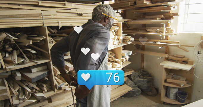Senior woodworker wearing apron inspecting lumber at woodshop, with social media overlay