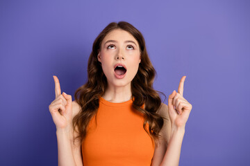 Fototapeta premium Adorable and charming, expressing surprise while standing against a vibrant purple backdrop, youthful and joyful