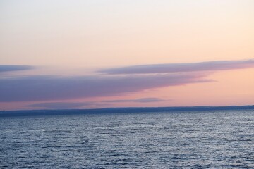 Sunset over the sea with cloudy sky