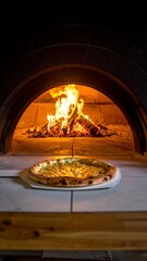 Pizza baking in a wood-fired oven (2)
