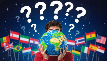 Boy holding globe surrounded by flags and question marks