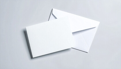 Blank invitation card with white envelope on light background