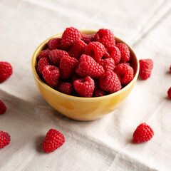Organic Raw Red Raspberries in a Bowl, side view.