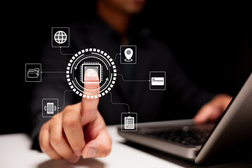 Cloud computing and secure digital connection. A businessman uses a touchscreen interface with laptop in a modern office to access data, payments, and global networks through smart technology.