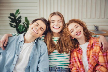 Group of cheerful friends enjoying time together in a cozy living space during a casual holiday weekend