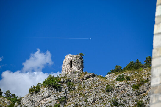 Old tower on a hill above the town of Livno. Vejs Tower, Livno, Bosnia and Herzegovina. Airplane above the old stone fortress.