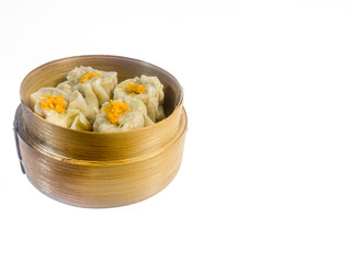 Traditional steamed dim sum dumplings in a bamboo basket isolated on a white background. Asian cuisine, Chinese food concept.
