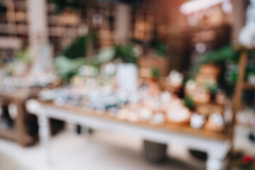 Blurred Background of a Flower Shop with Beautiful Floral Arrangements and Decorative Items Displayed on Tables